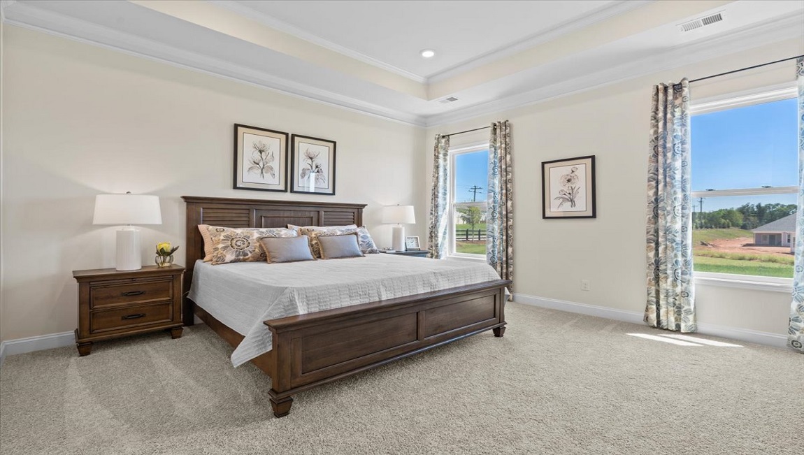 Bedroom with carpet and window.a