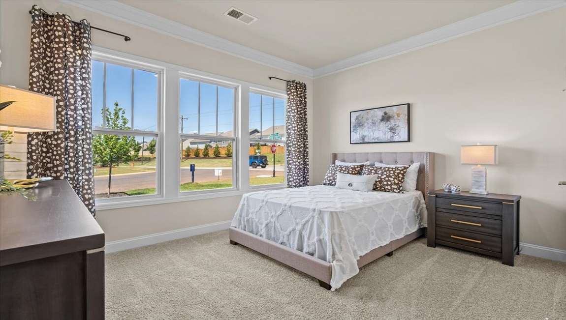 Bedroom with carpet and window.