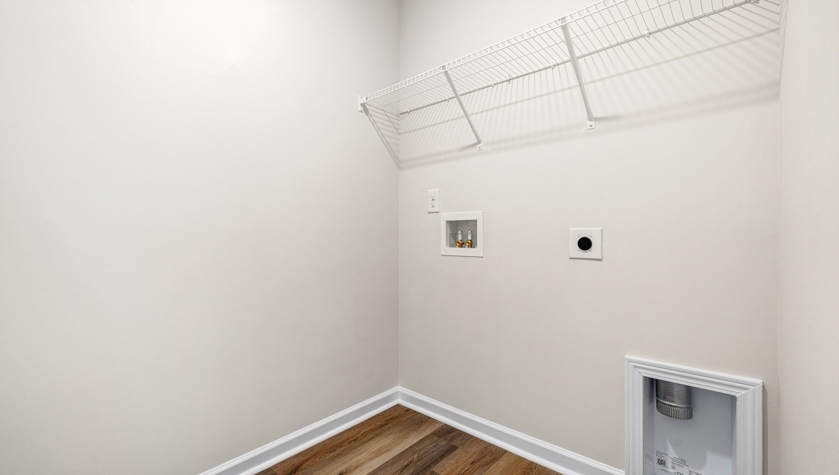 Laundry room with hanging storage racks.