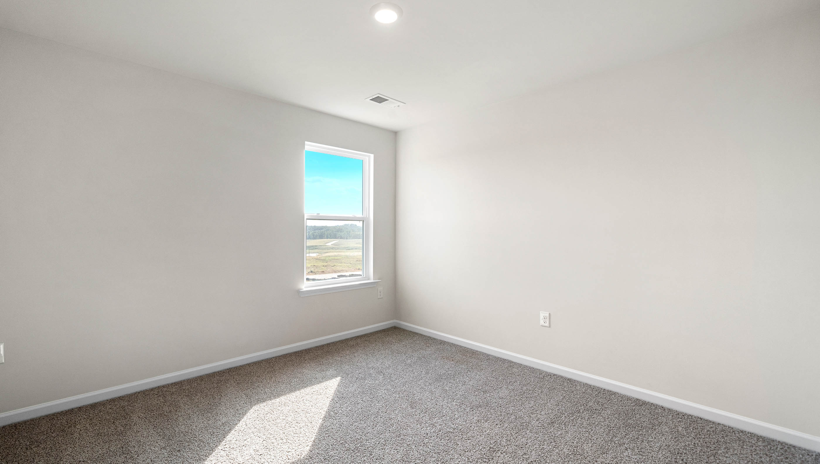 Bedroom with carpet and window.