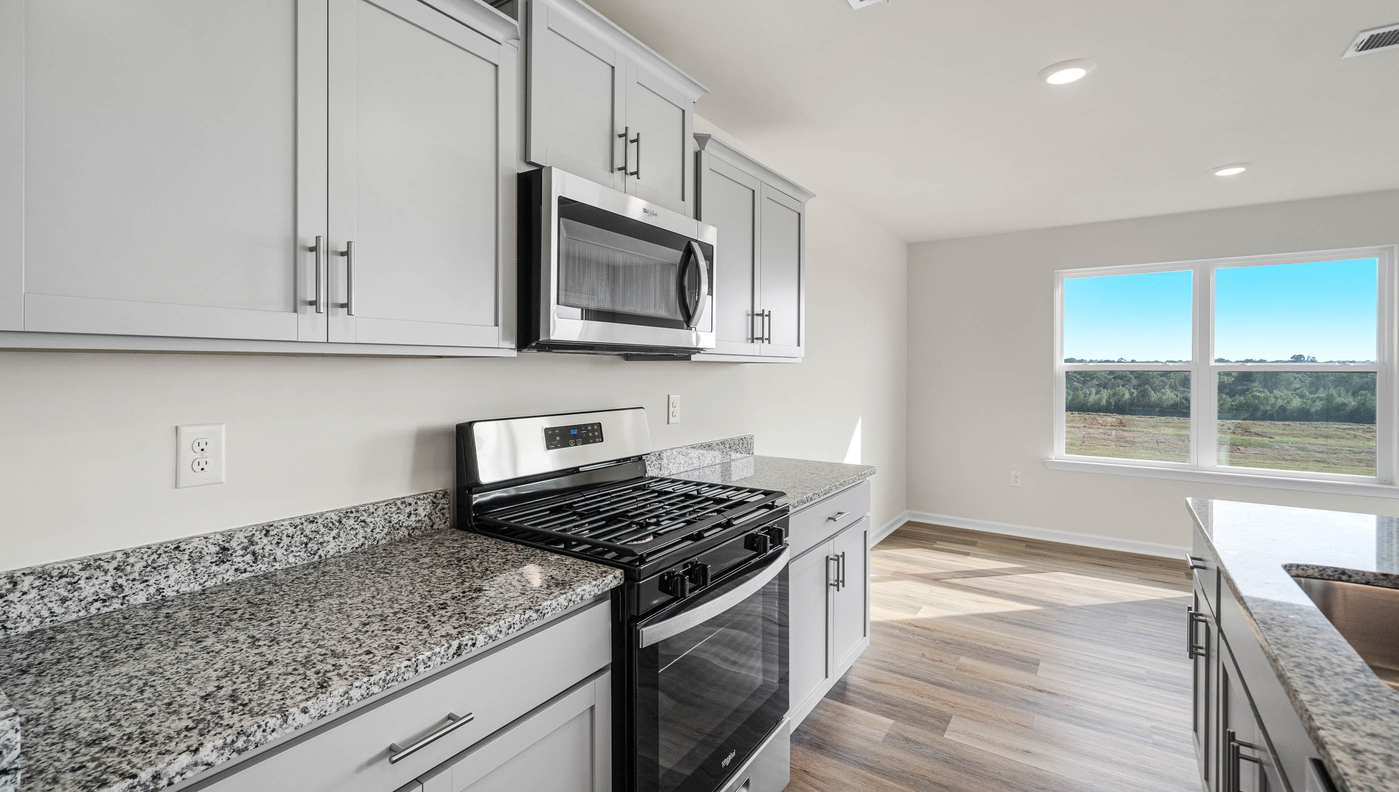 Kitchen and island with granite counter tops.