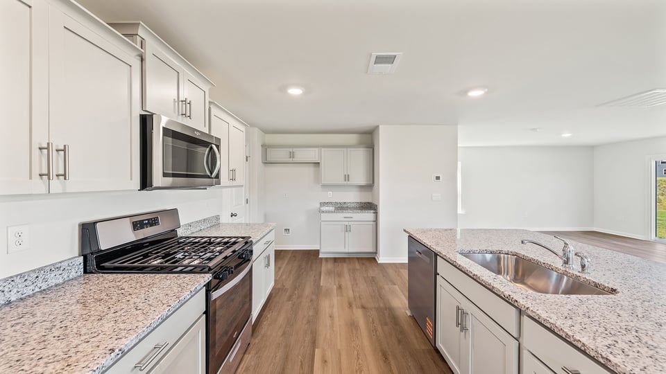 Kitchen and island with granite counter tops.