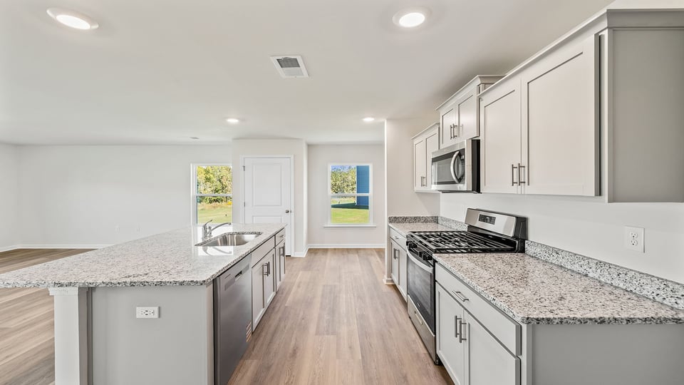 Kitchen and island with granite counter tops.