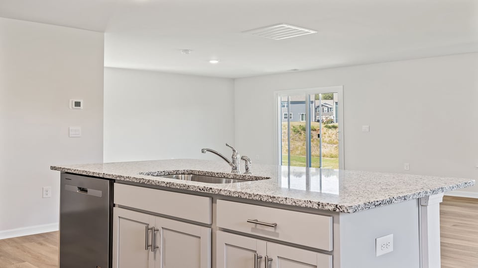 Kitchen and island with granite counter tops.