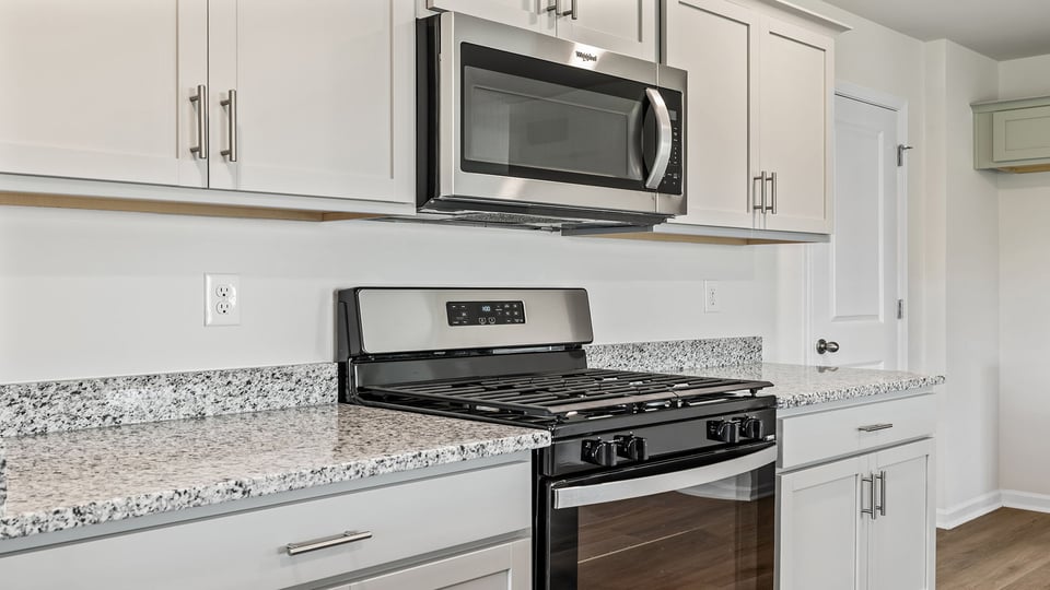 Kitchenwith granite counter tops and stainless steel appliances.