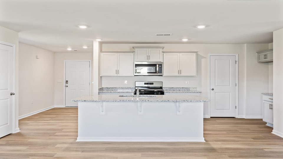 Kitchen and island with granite counter tops.