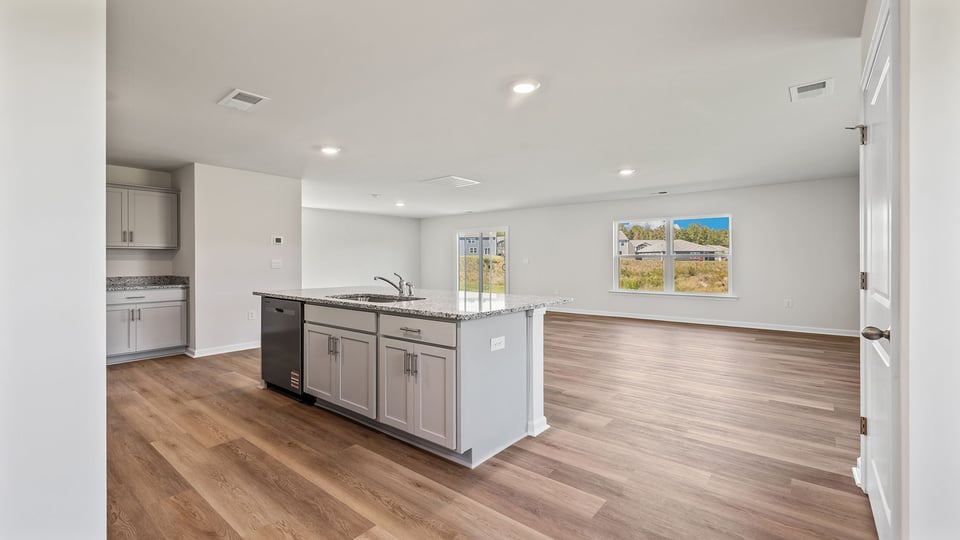 Kitchen and island with granite counter tops.