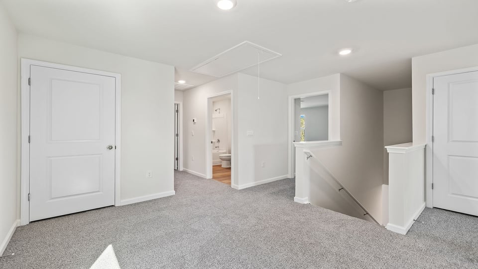 Loft area with carpet.