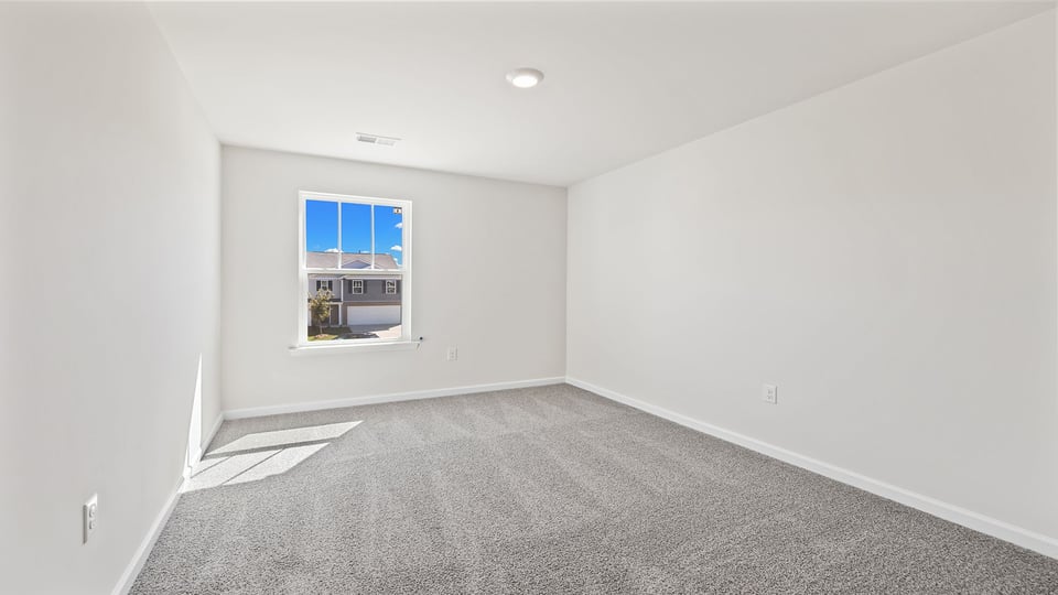 Bedroom with carpet and window.