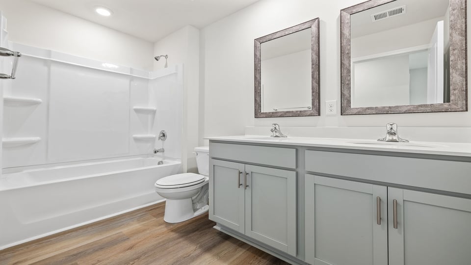 Bathroom with dual vanity and tub.