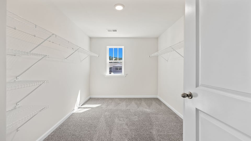 Bedroom with carpet and window.
