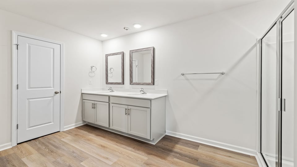 Bathroom with dual vanity and walk in shower.