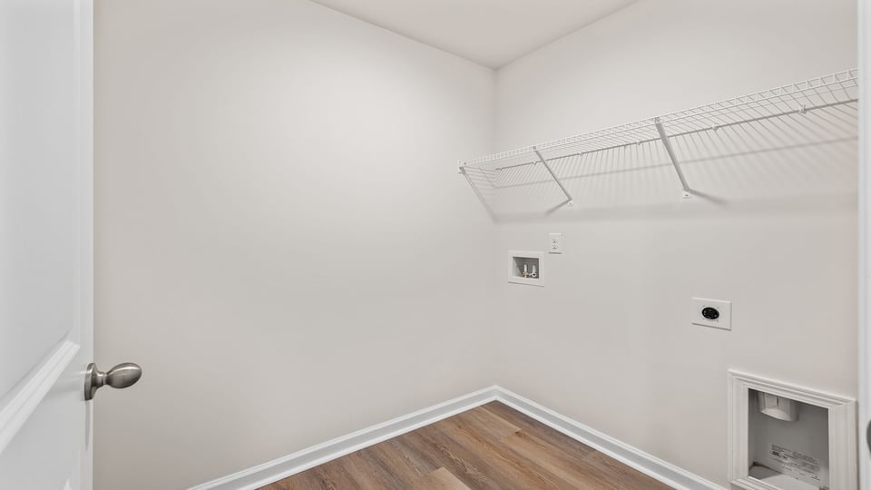 Walk in laundry room with shelves.