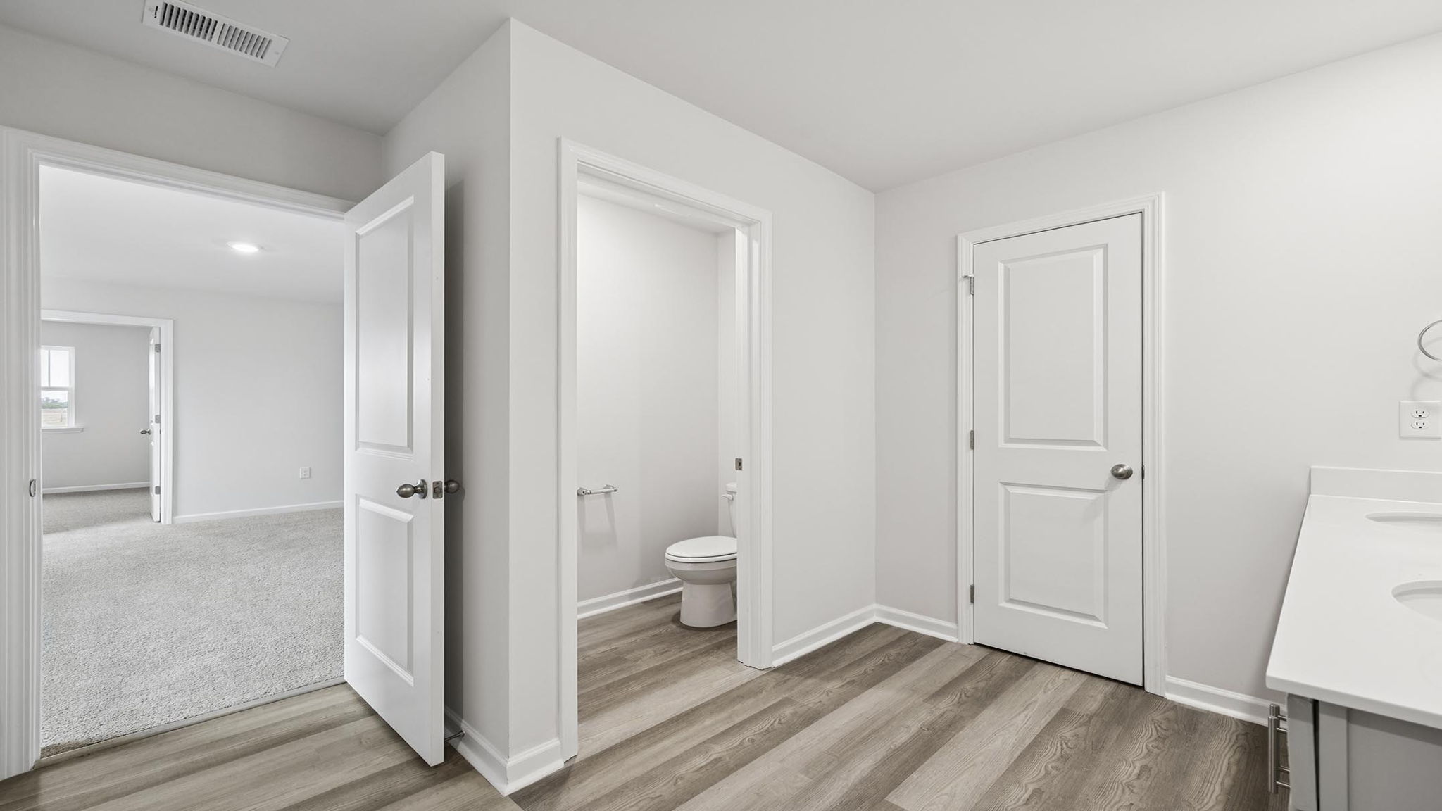 Bathroom with double sink and walk in shower.