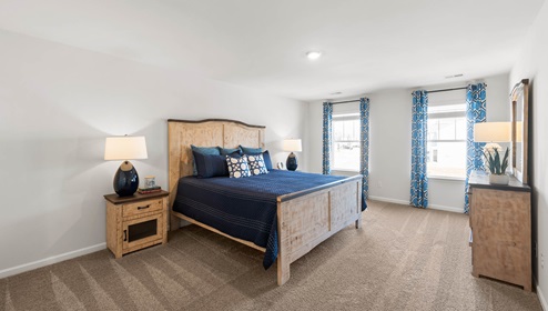 Bedroom with carpet and window.
