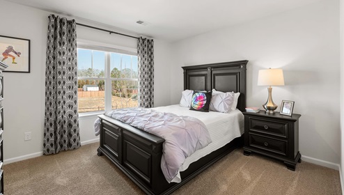 Bedroom with carpet and window.