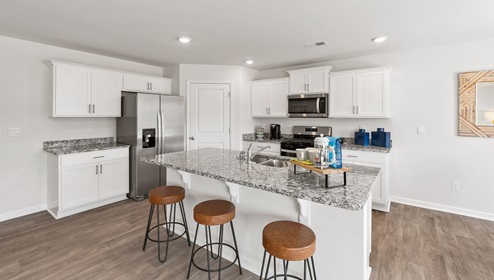 Kitchen and island with granite counter tops.