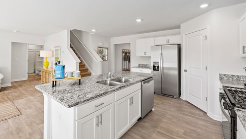 Kitchen and island with granite counter tops.