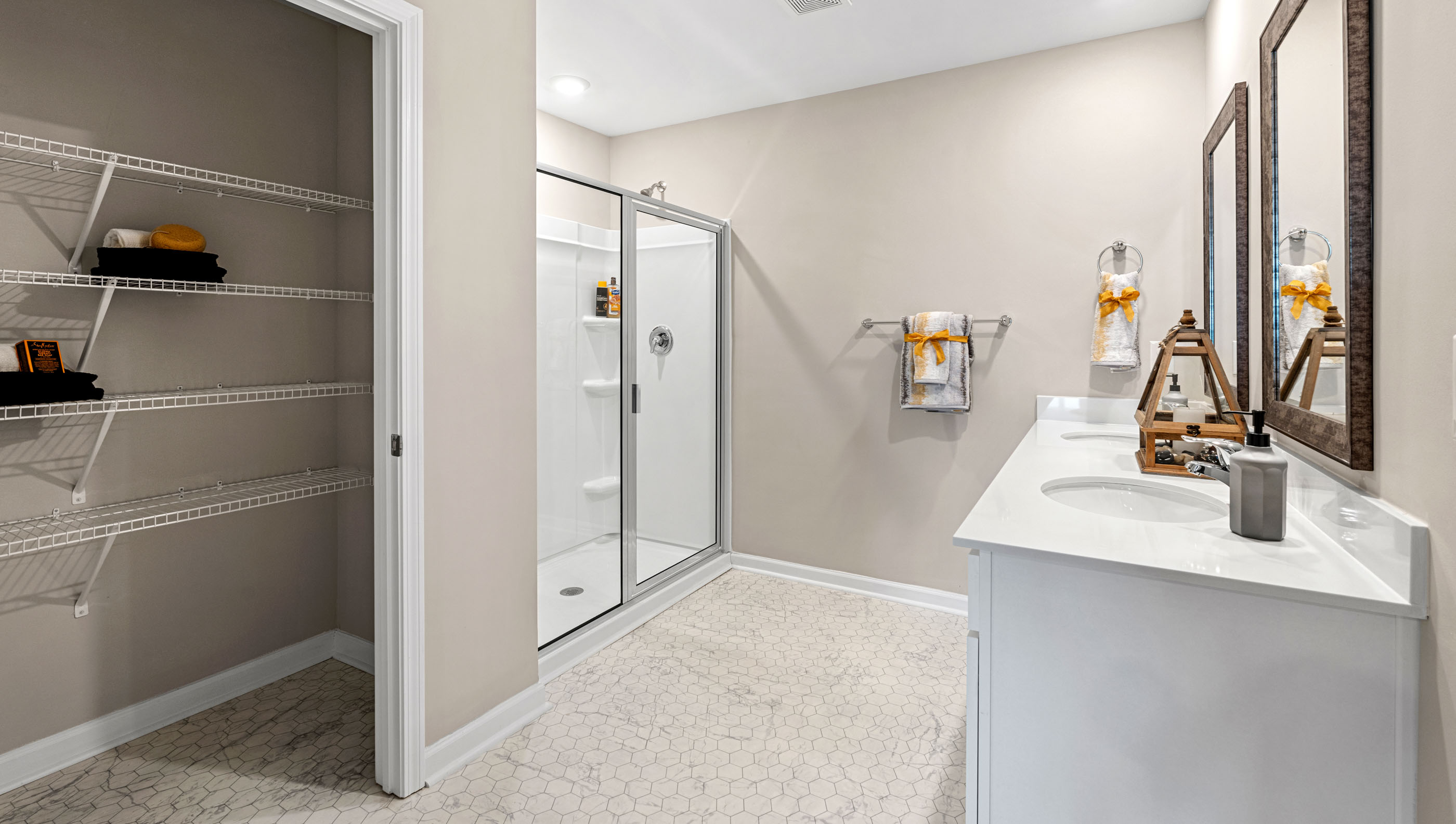 Bathroom with double vanity sink and shower.