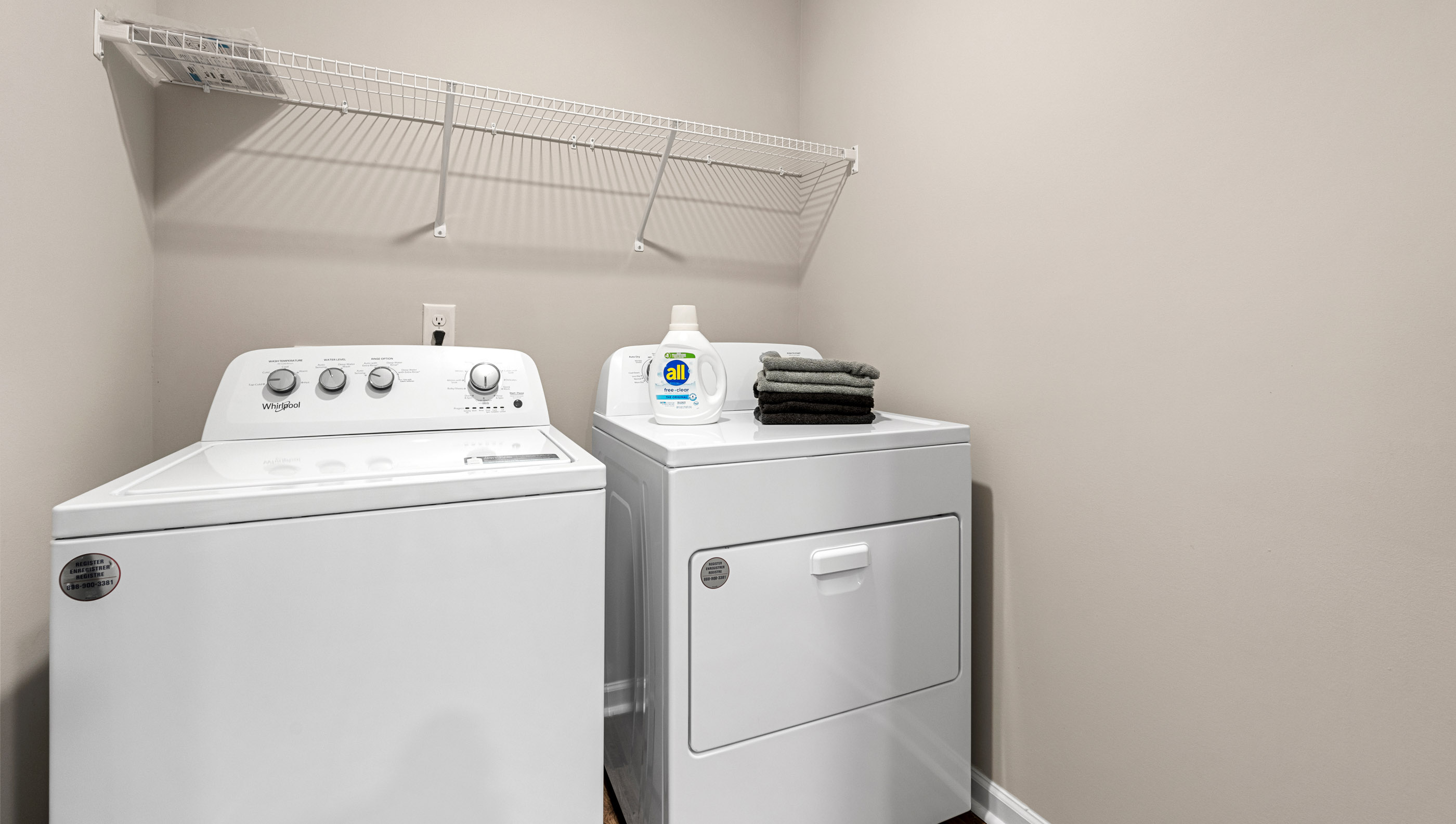 Laundry room with hanging storage racks.