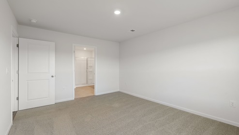 Bedroom with carpet and window.