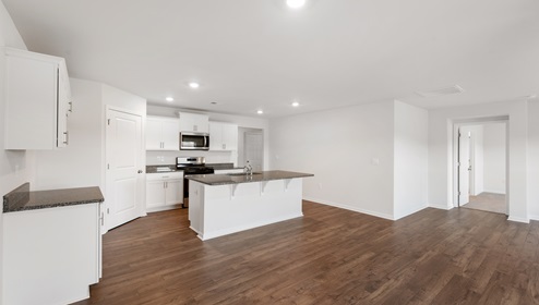 Kitchen and island with granite counter tops.