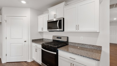Kitchen and island with granite counter tops.
