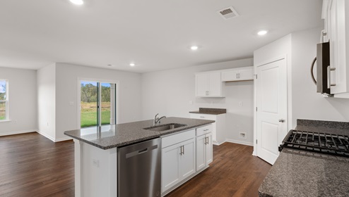 Kitchen and island with granite counter tops.
