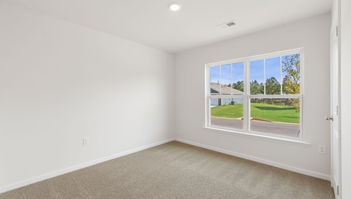 Bedroom with carpet and window.