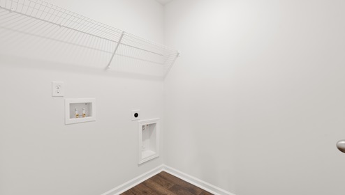 Laundry room with hanging storage racks.