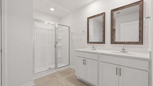 Bathroom with shower and double vanity sink.