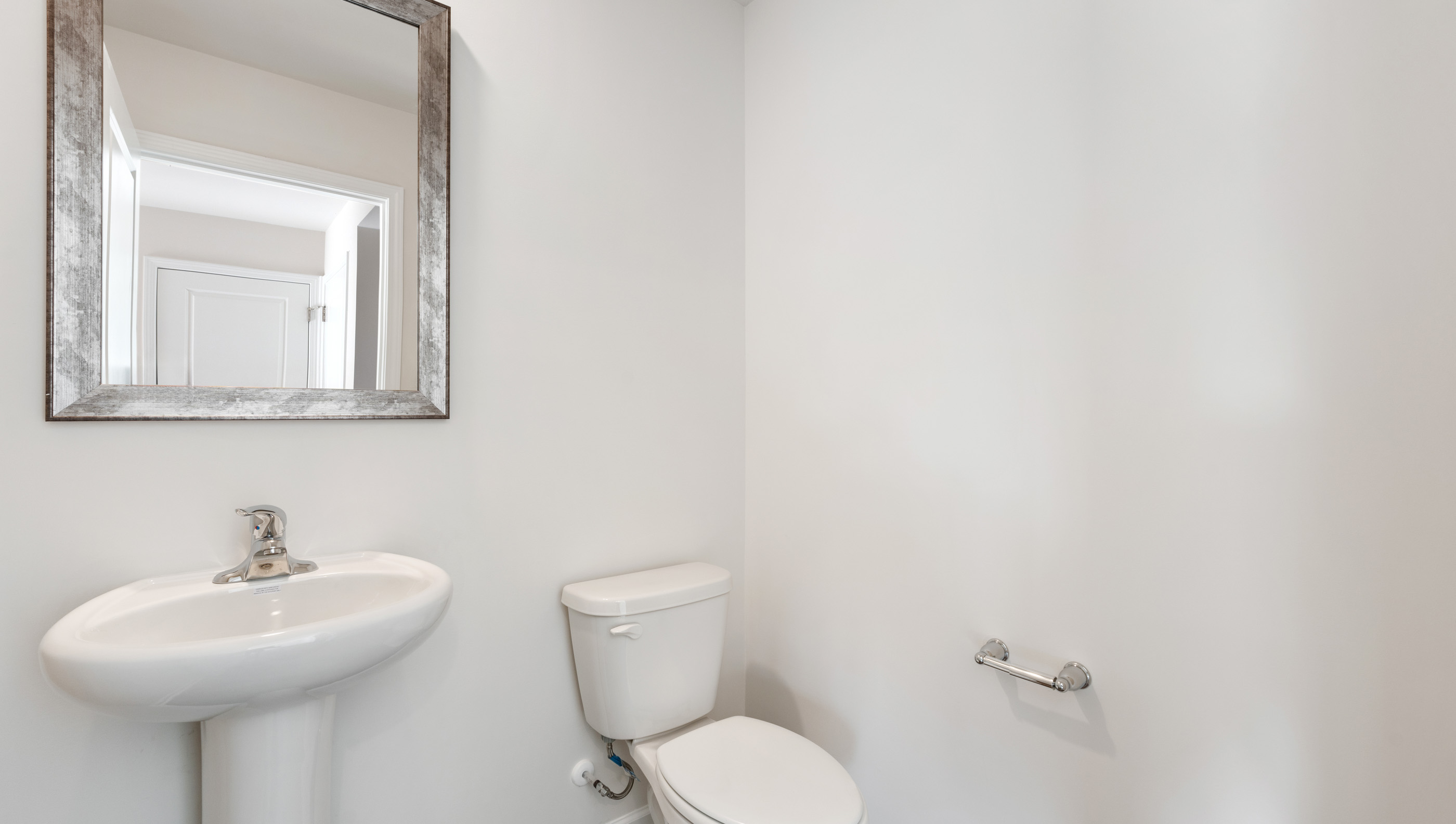 Half bathroom with mirror.