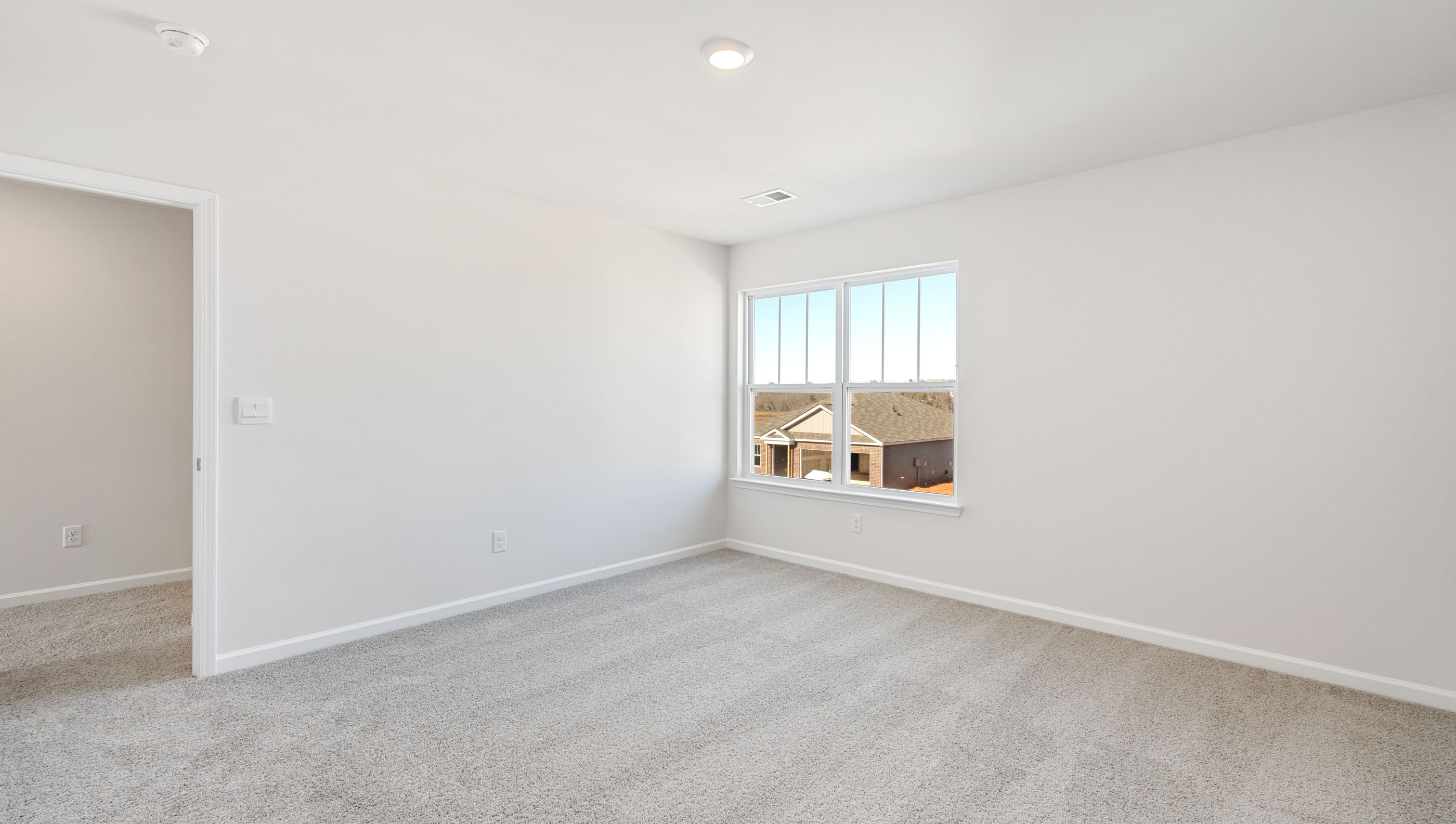 Bedroom with carpet and window.