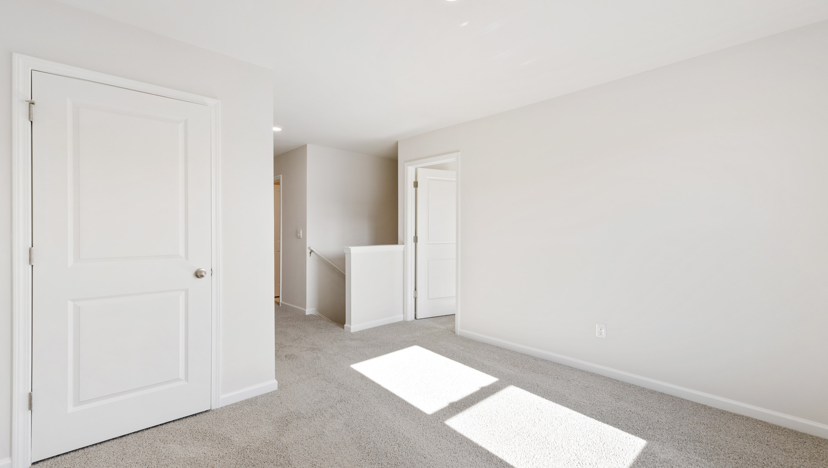 Bedroom with carpet and window.