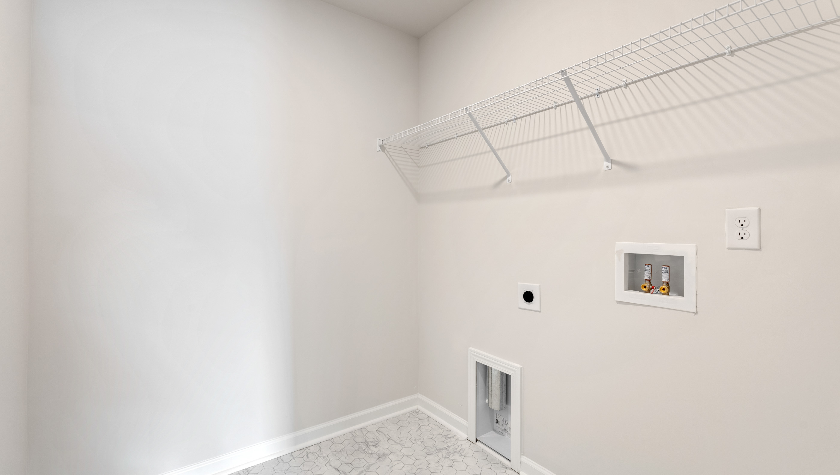 Laundry room with hanging storage racks.