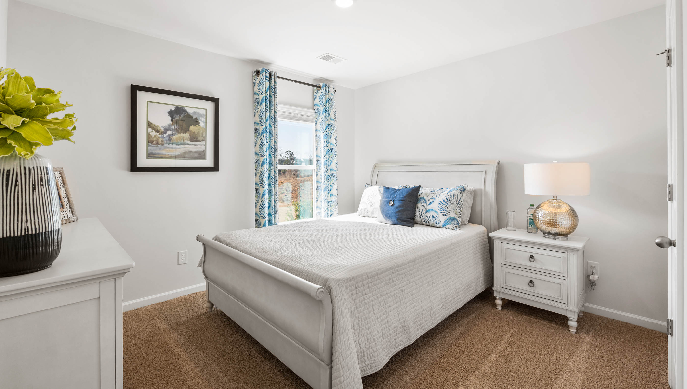 Bedroom with carpet and window.