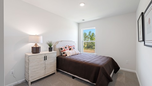 Bedroom with carpet and window.