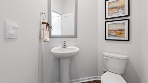 Half bathroom with mirror.