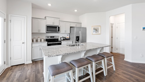 Kitchen and island with granite counter tops.