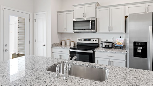 Kitchen and island with granite counter tops.