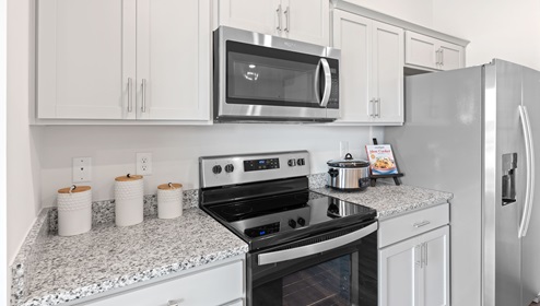 Kitchen and island with granite counter tops.