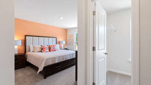 Bedroom with carpet and window.