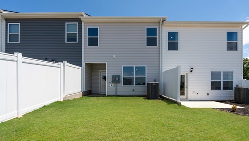Back exterior of home with large backyard.