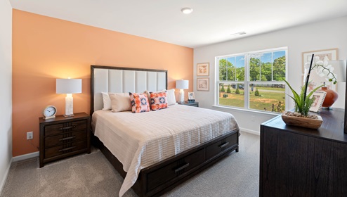 Bedroom with carpet and window.