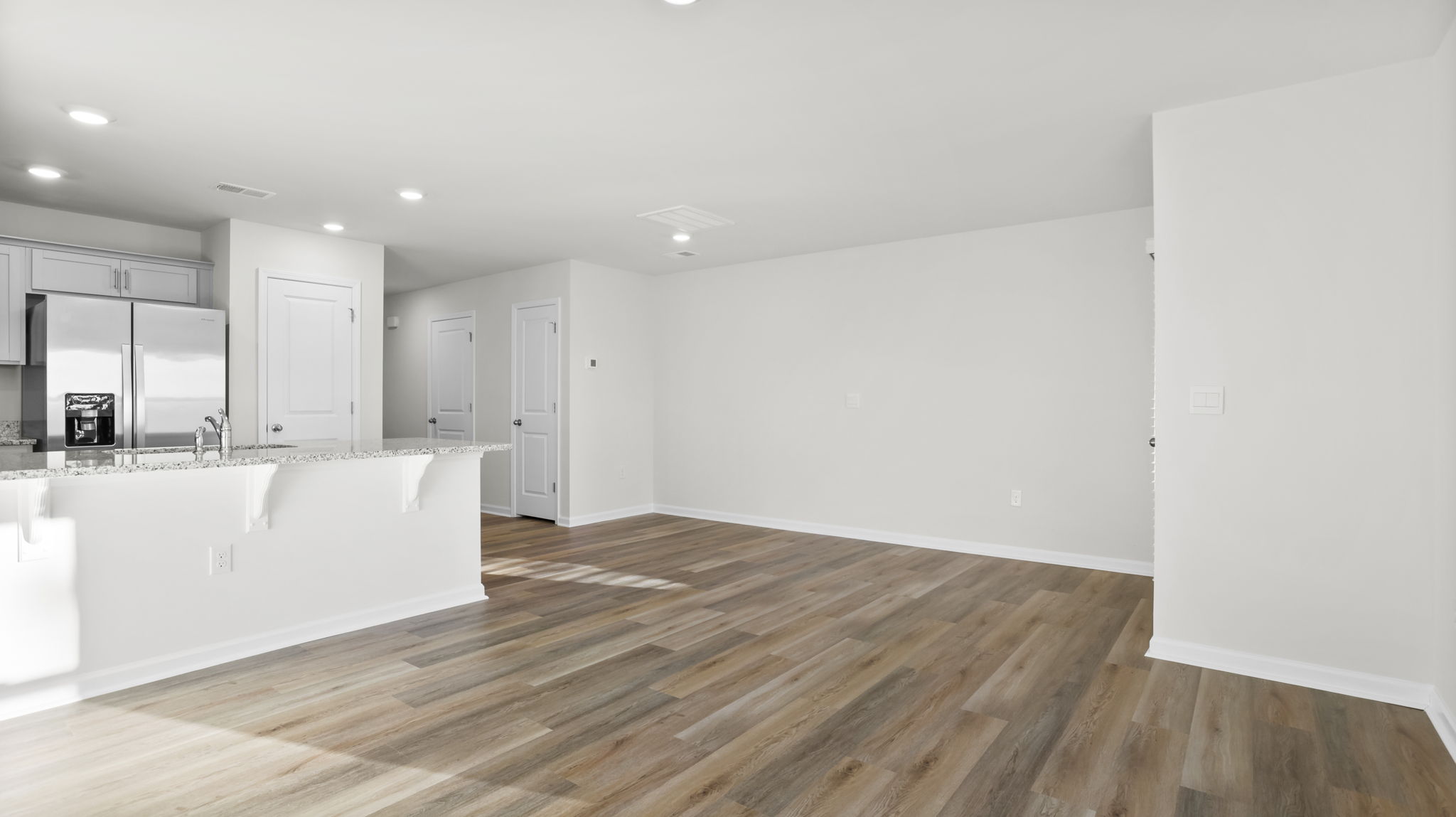 View of kitchen and dining area from family room.