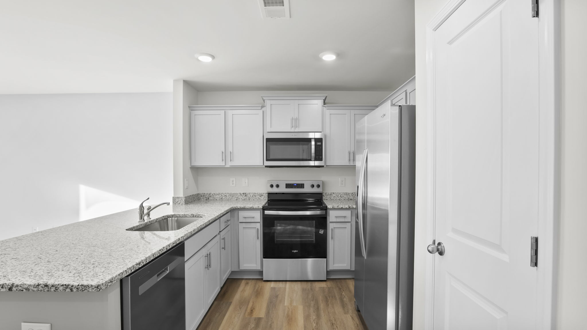 Kitchen features recessed lighting.