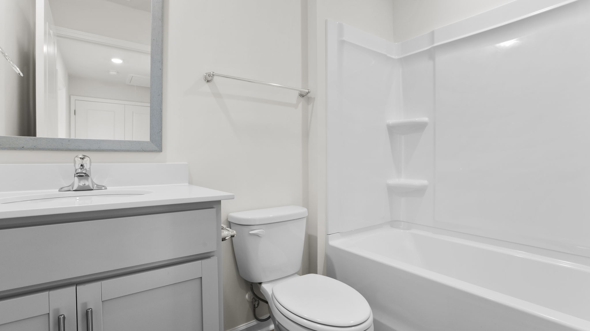 Hall bathroom with vanity cand combination shower / tub.