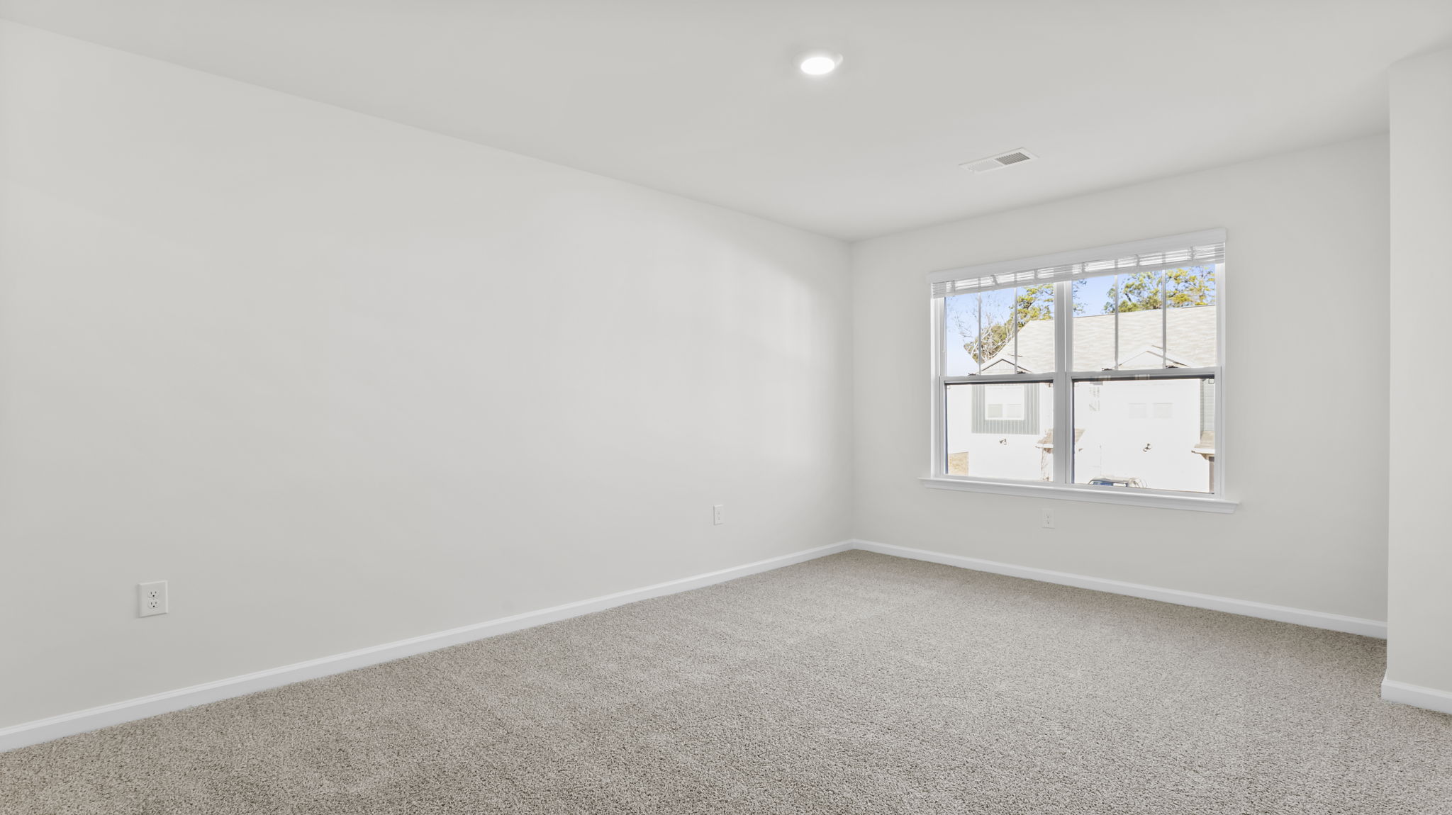 Primary bedroom with large window.
