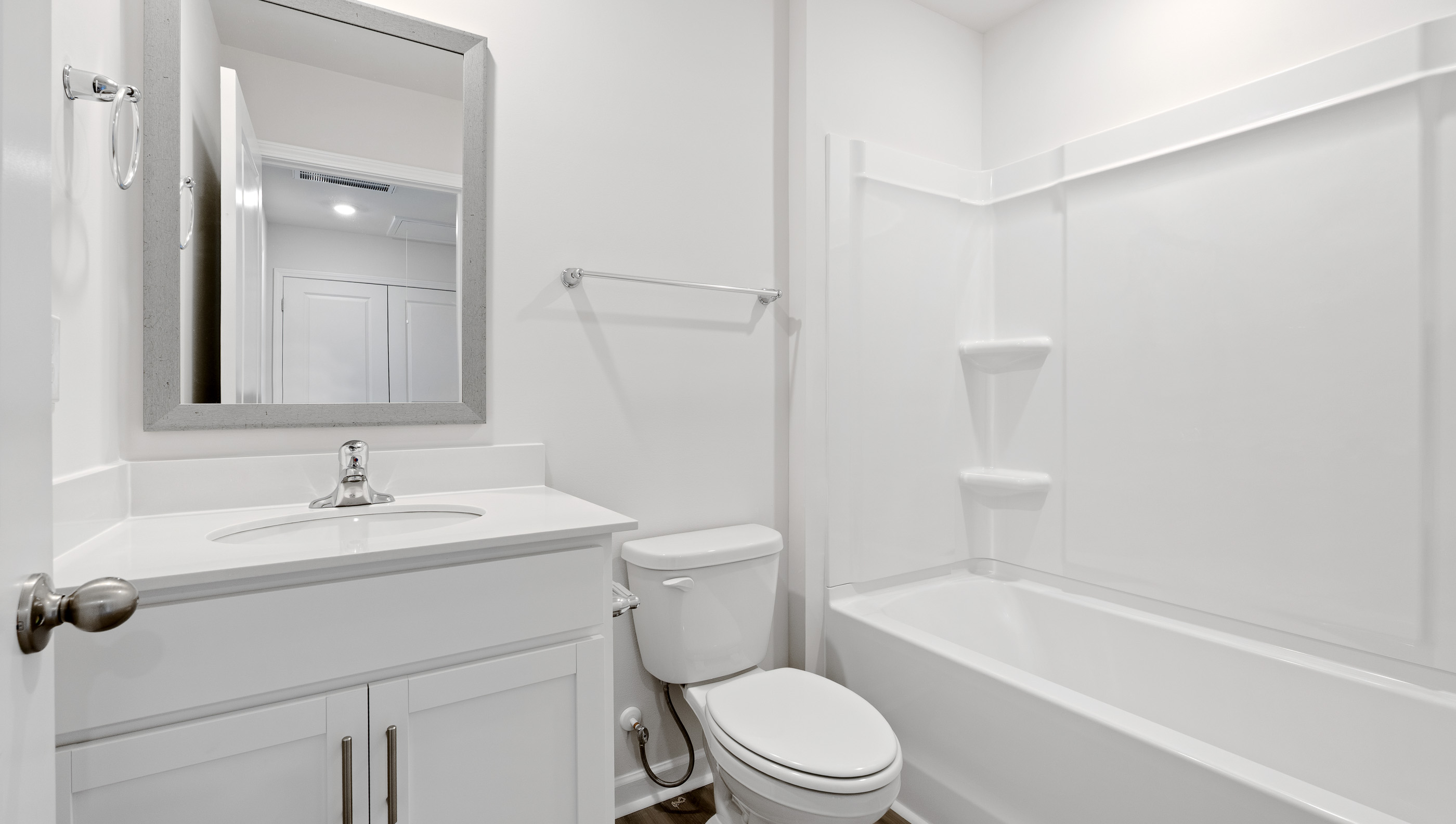 Hall bathroom with vanity and combination shower / tub.