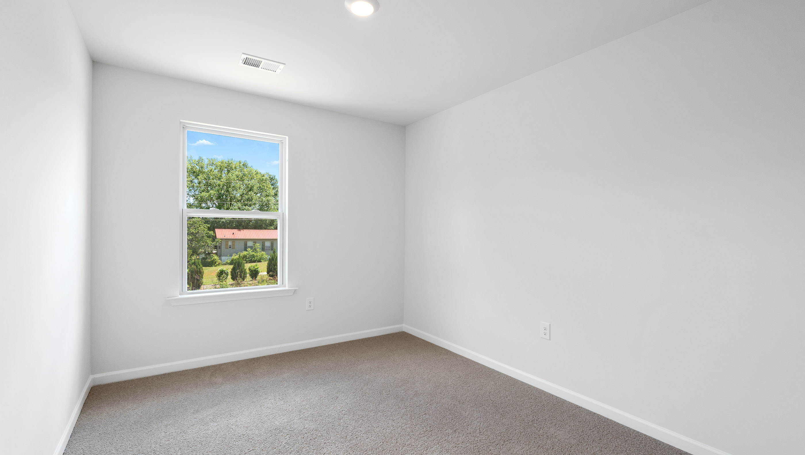 Bedroom with window and carpet.